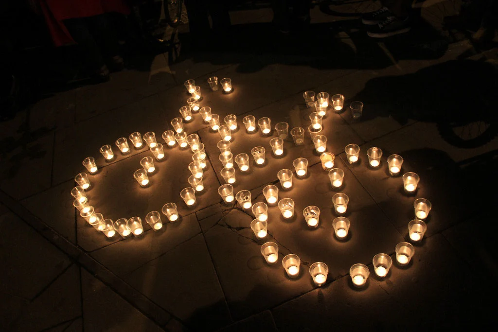 Candles formed into the shape of a bicycle at Kings Cross Christmas Vigil - Andreas Kambanis - Flickr